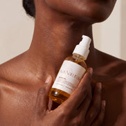 Glow Oil held at the collarbone