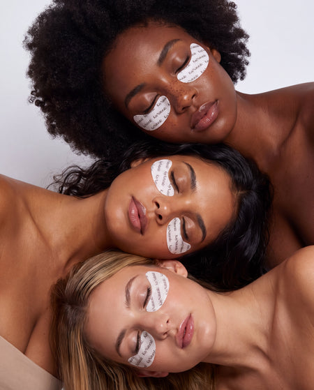 Three models wearing the Glow Undereye Patches