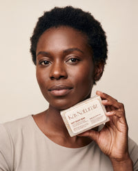 Model holding the KayNaturalz Oat Soap Bar